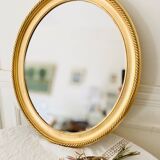 Oval wall mirror in gilded wood