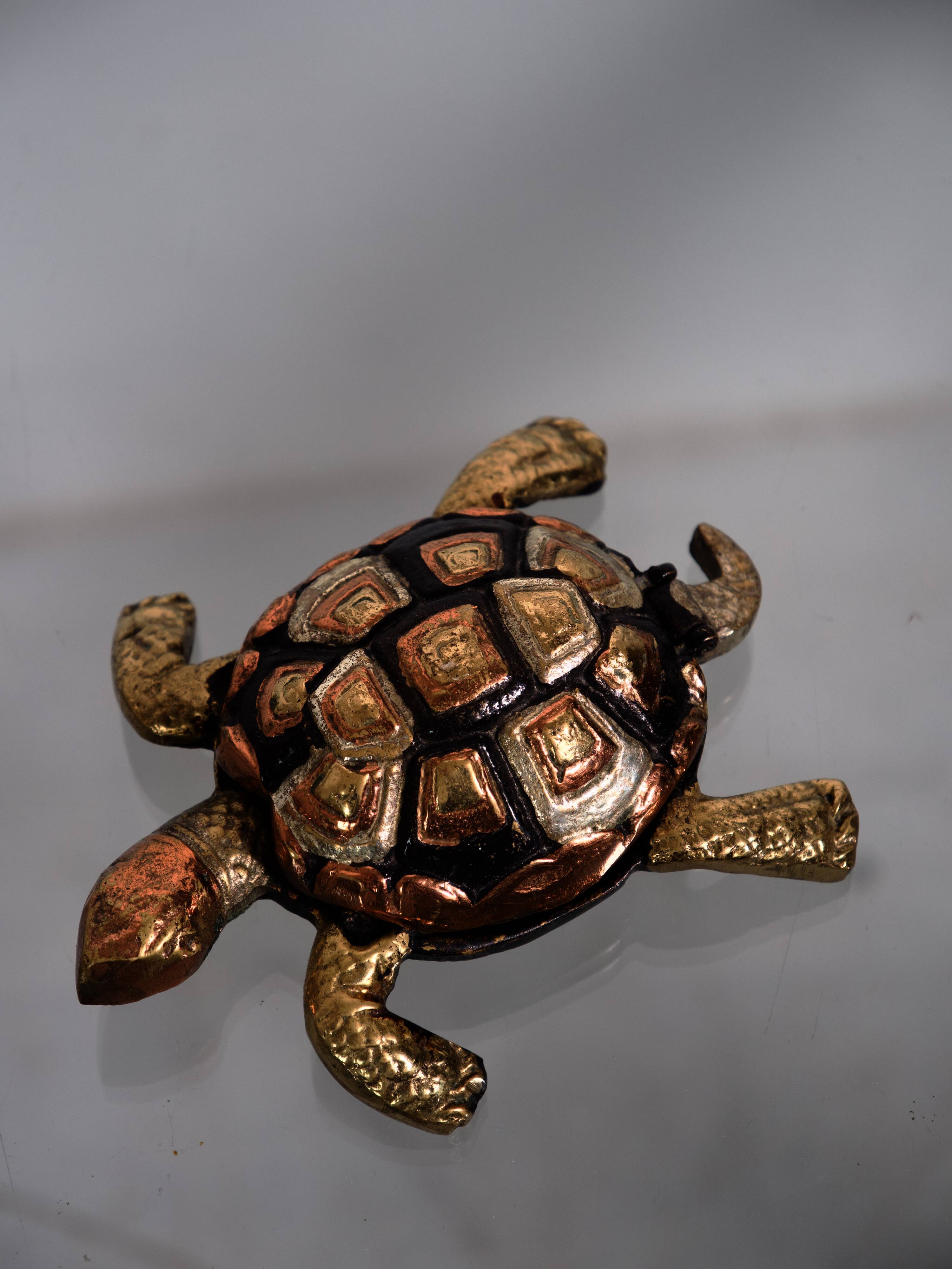 Golden brass turtle in decorative ashtray