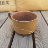 Brown sandstone cup with white spots