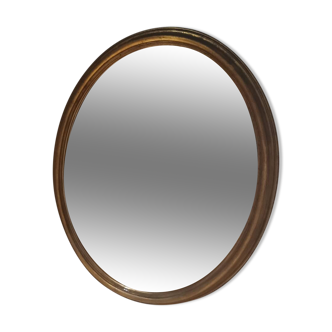 Miroir ovale, bois et feuille d'or années 70