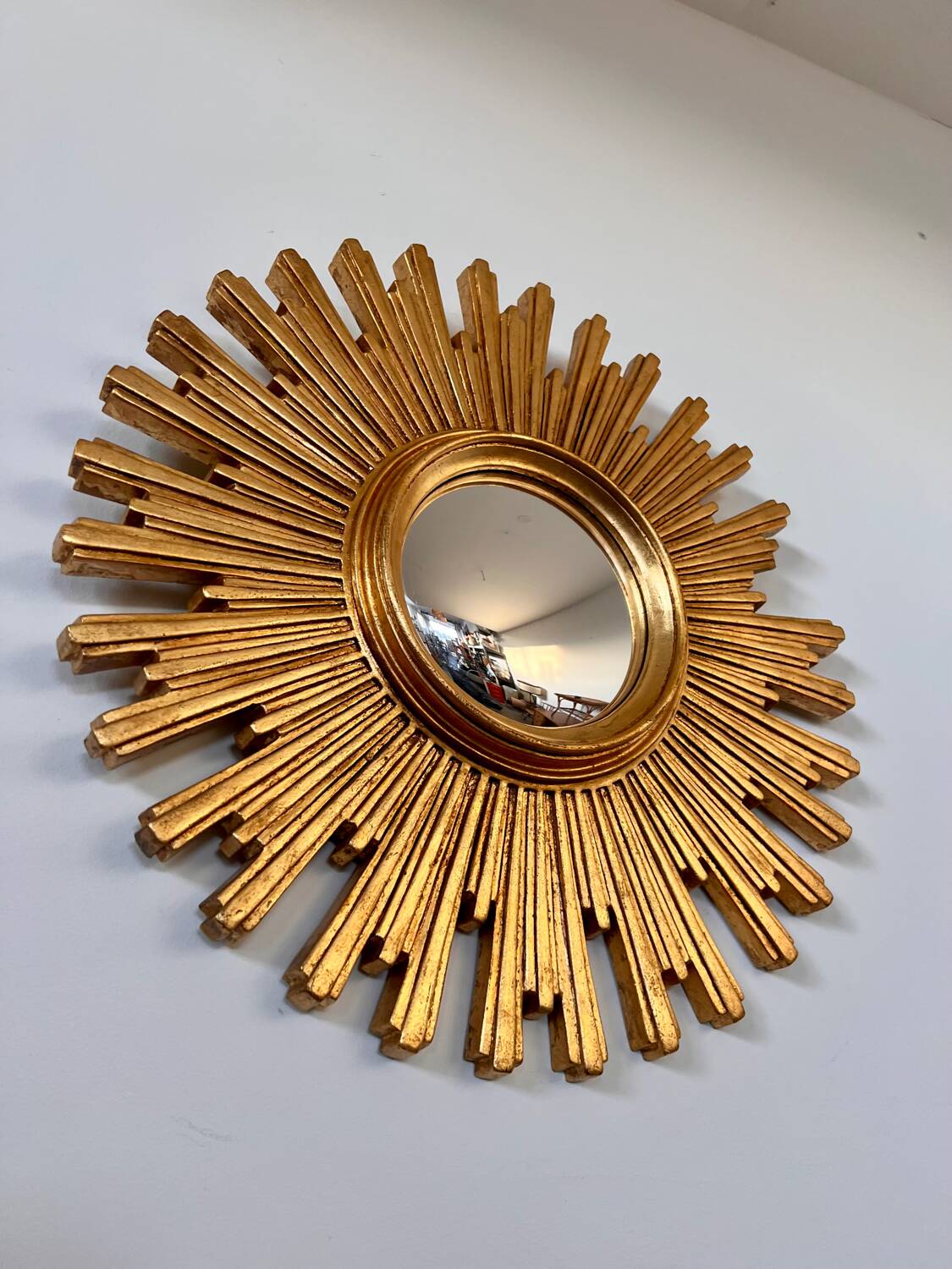 Old large golden sun mirror with rounded witch's eye in vintage resin from the 70s