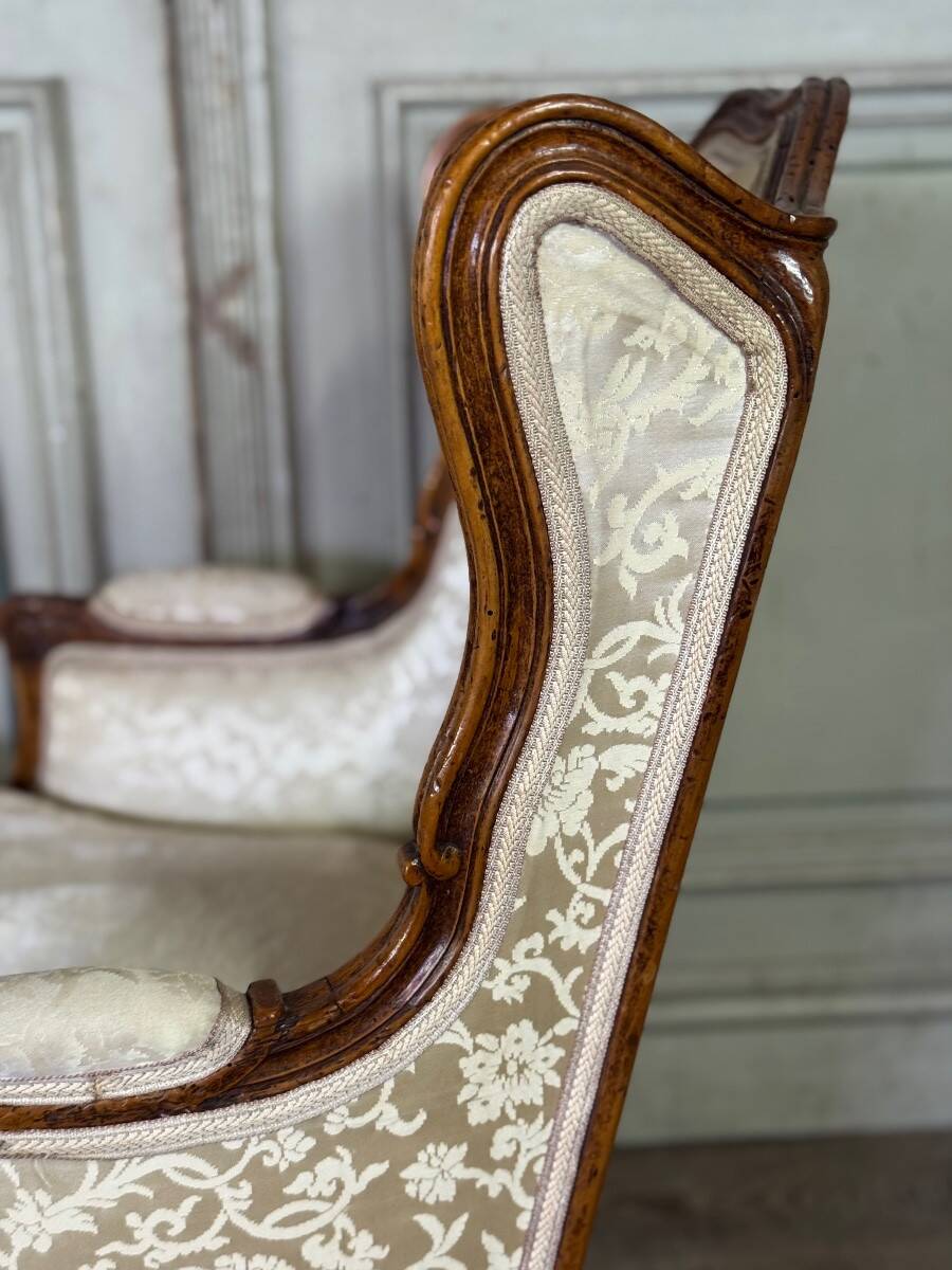 Pair of small Louis XV style wing chairs in carved walnut, Bosson stamp