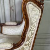 Pair of small Louis XV style wing chairs in carved walnut, Bosson stamp