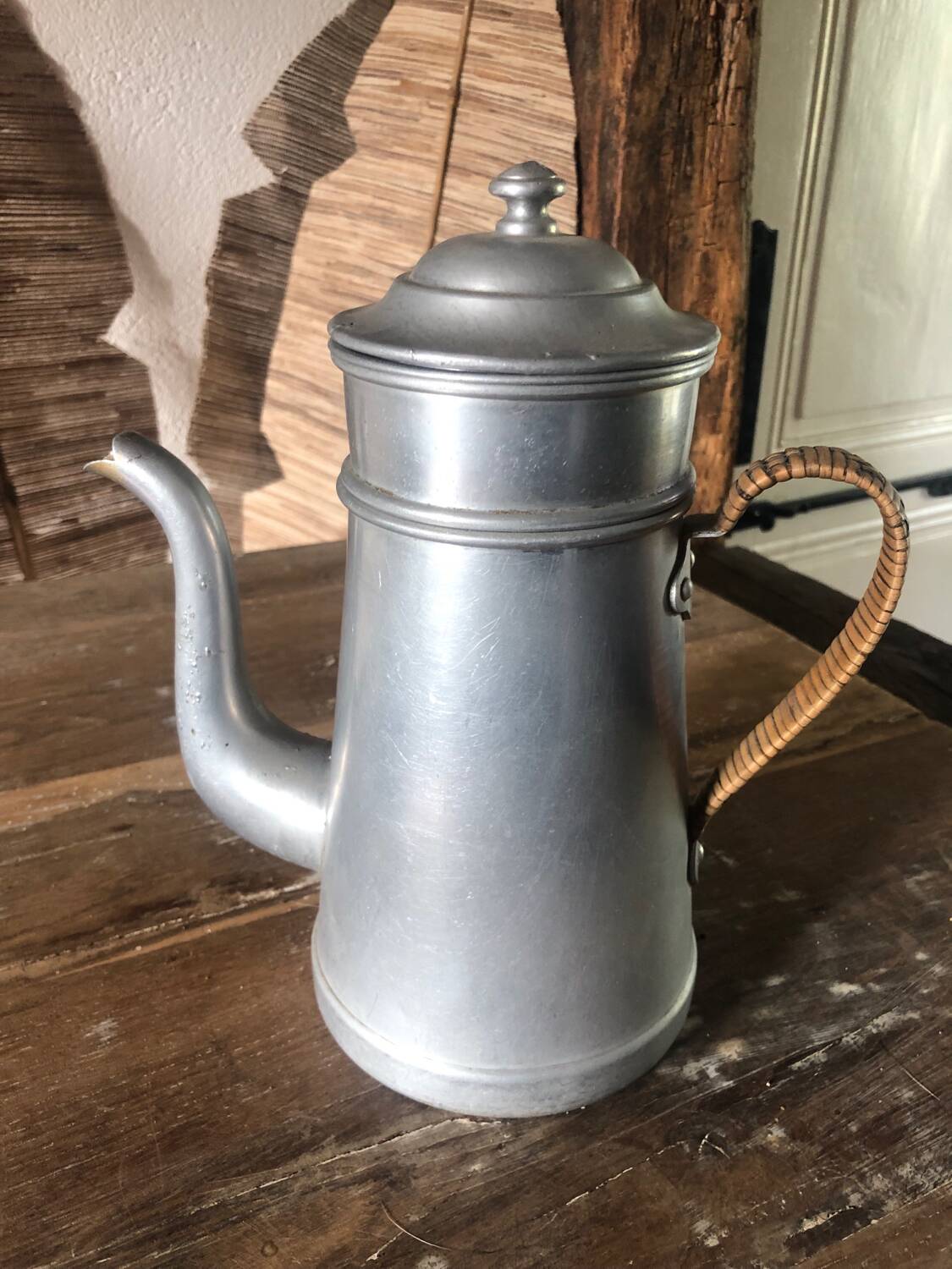 Old aluminum coffee maker, woven wicker handle