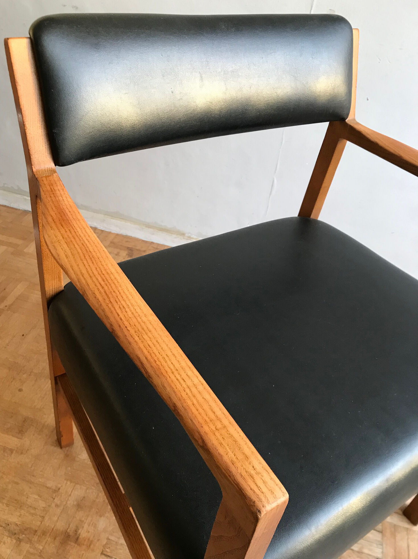 Chair in light teak and black skaï from the 1960s