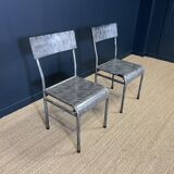 Pair of gray metal industrial chairs