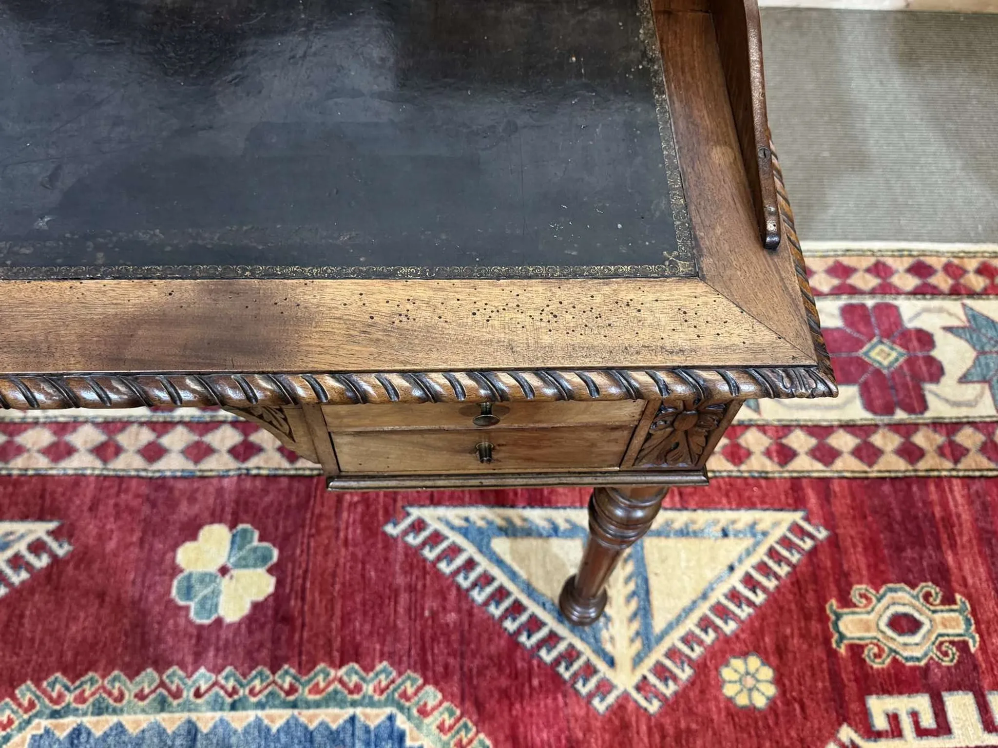 Louis XVI style desk from the late 19th century in walnut with a leather top.