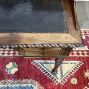 Louis XVI style desk from the late 19th century in walnut with a leather top.
