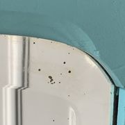 Beveled mirror on turquoise Parisian door