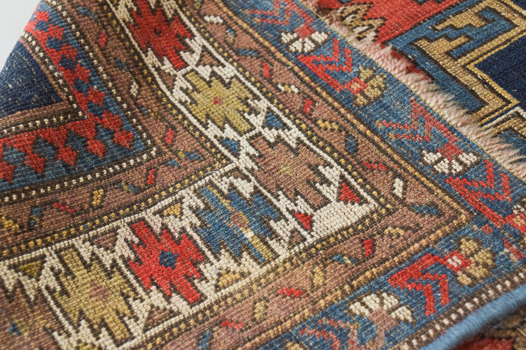 Handwoven blue ground persian rug with bird-like figures