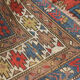 Handwoven blue ground persian rug with bird-like figures