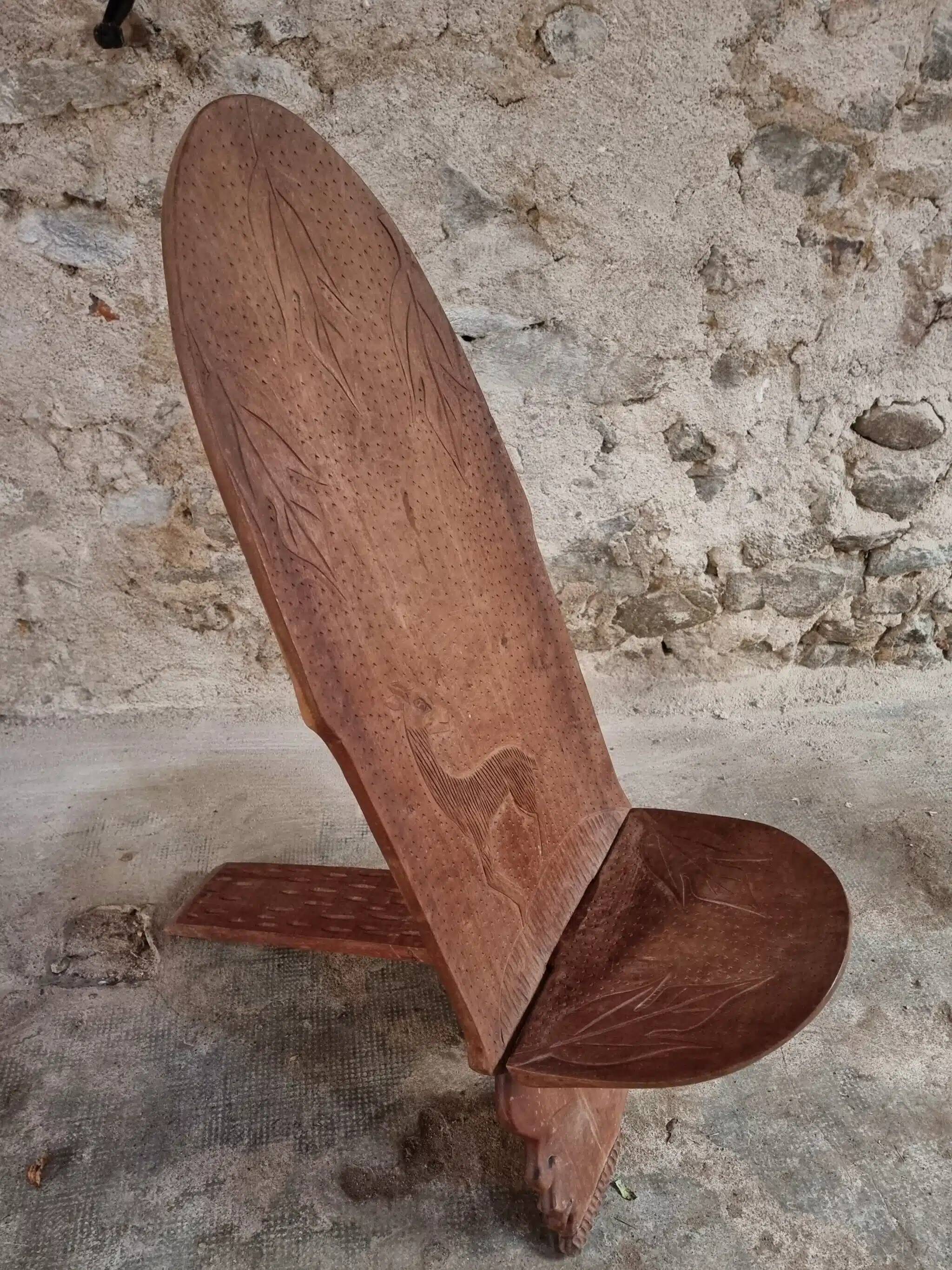 Pair of hand-carved wooden folding chairs – African origin, animal and face motifs, mid-20th century