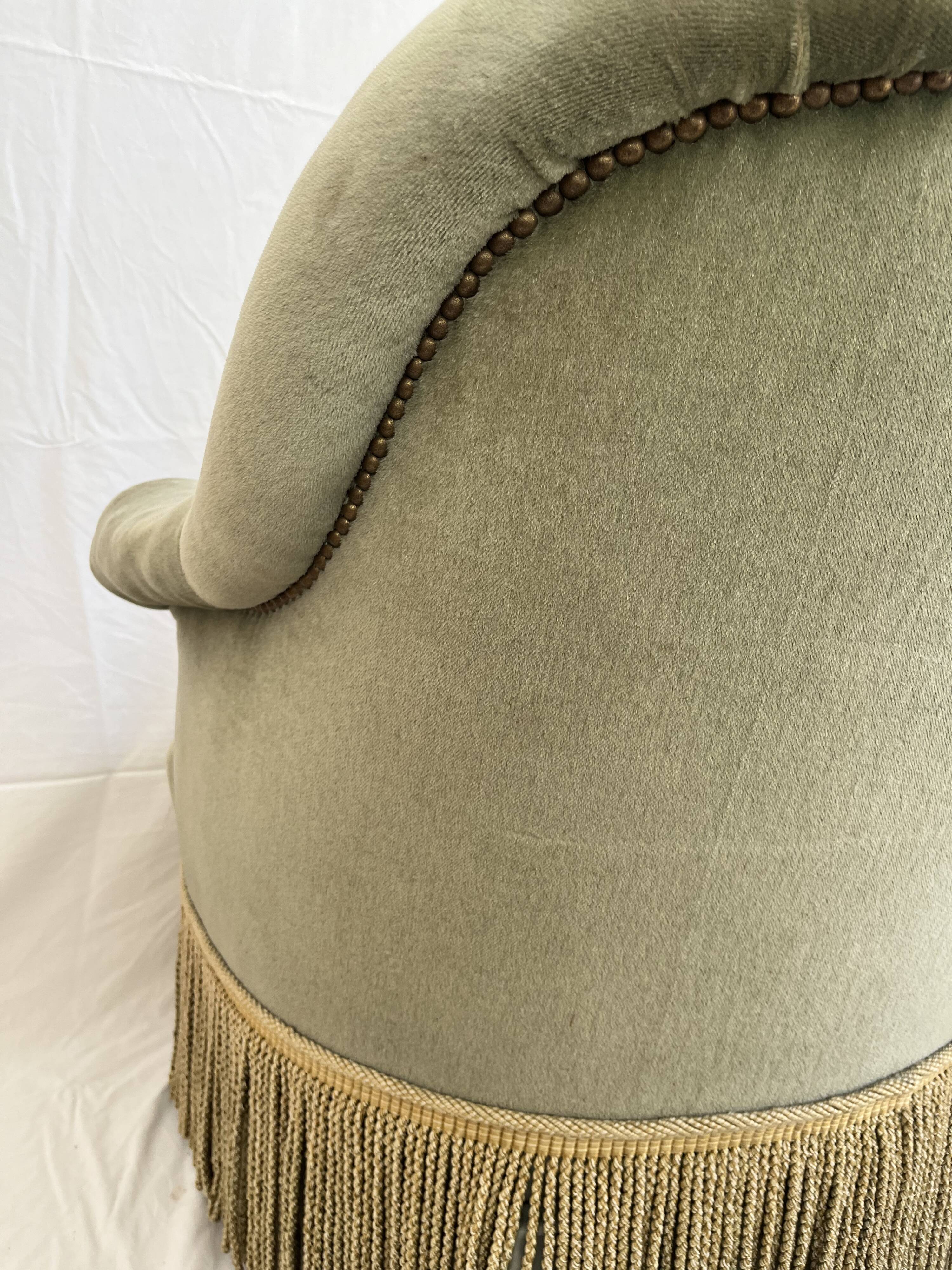sage green toad armchairs with gold fringe
