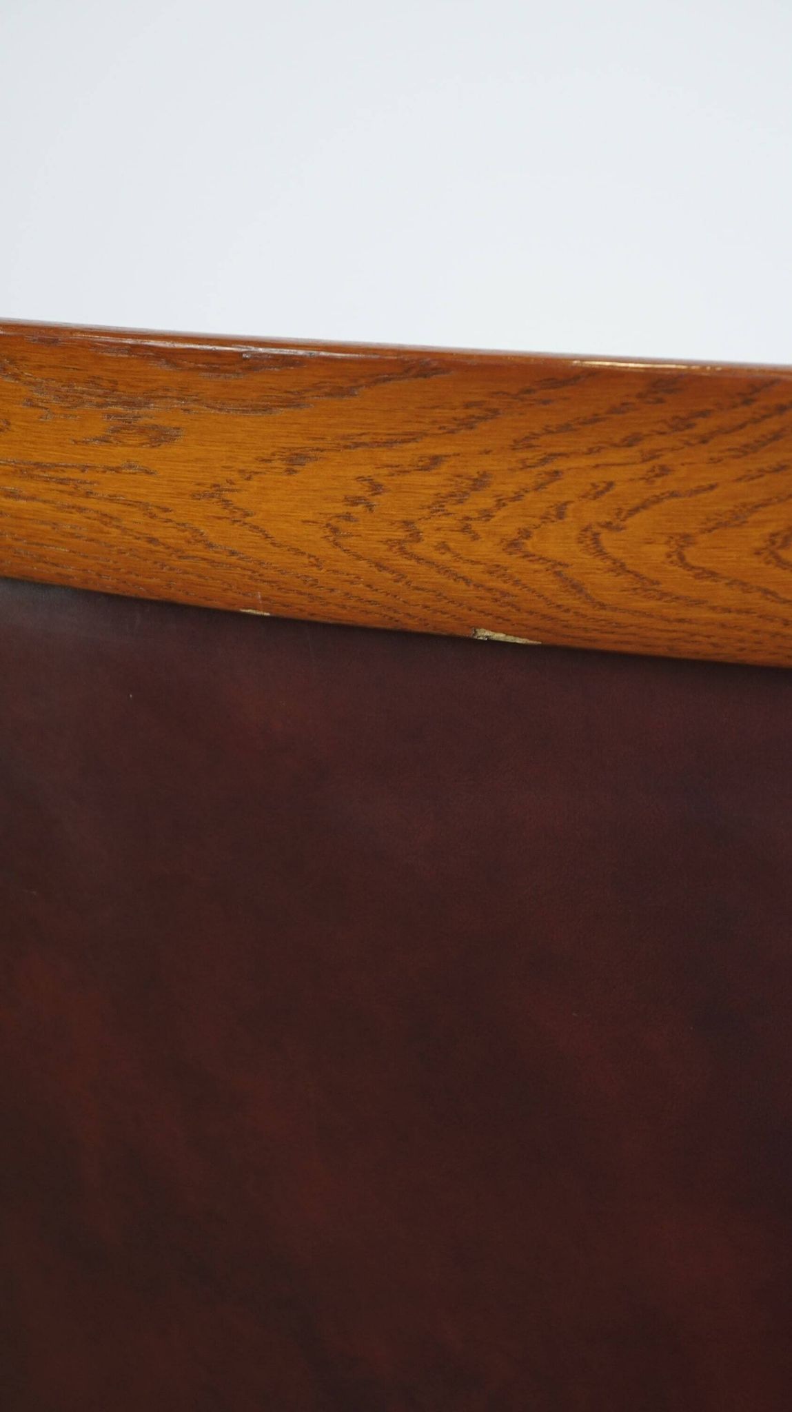 Very comfortable classic cowhide armchair with a high back in a mild Art Deco style