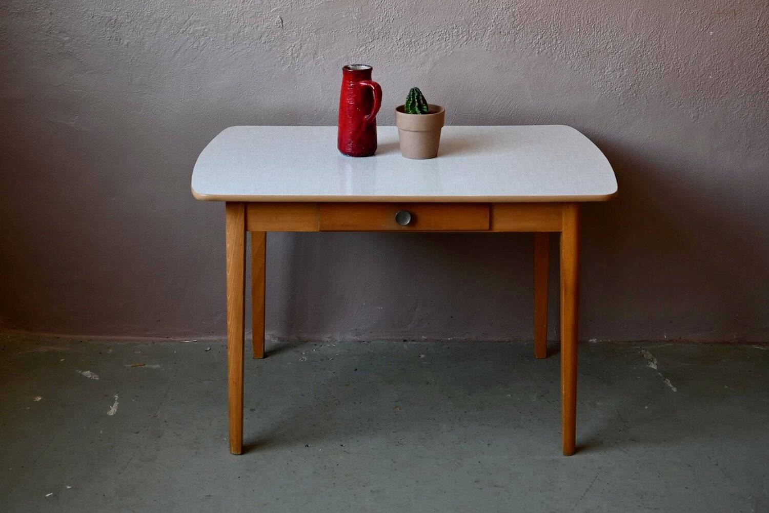 1950s Formica kitchen table with tapered legs and vintage drawer.