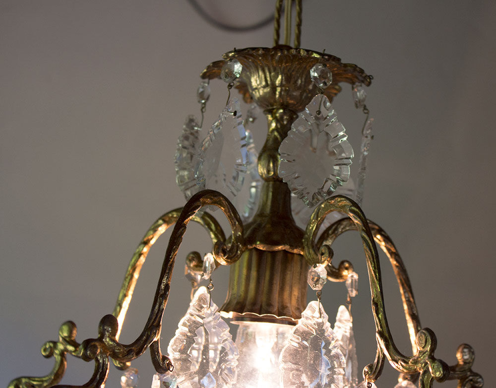 Old brass chandelier with glass stamps