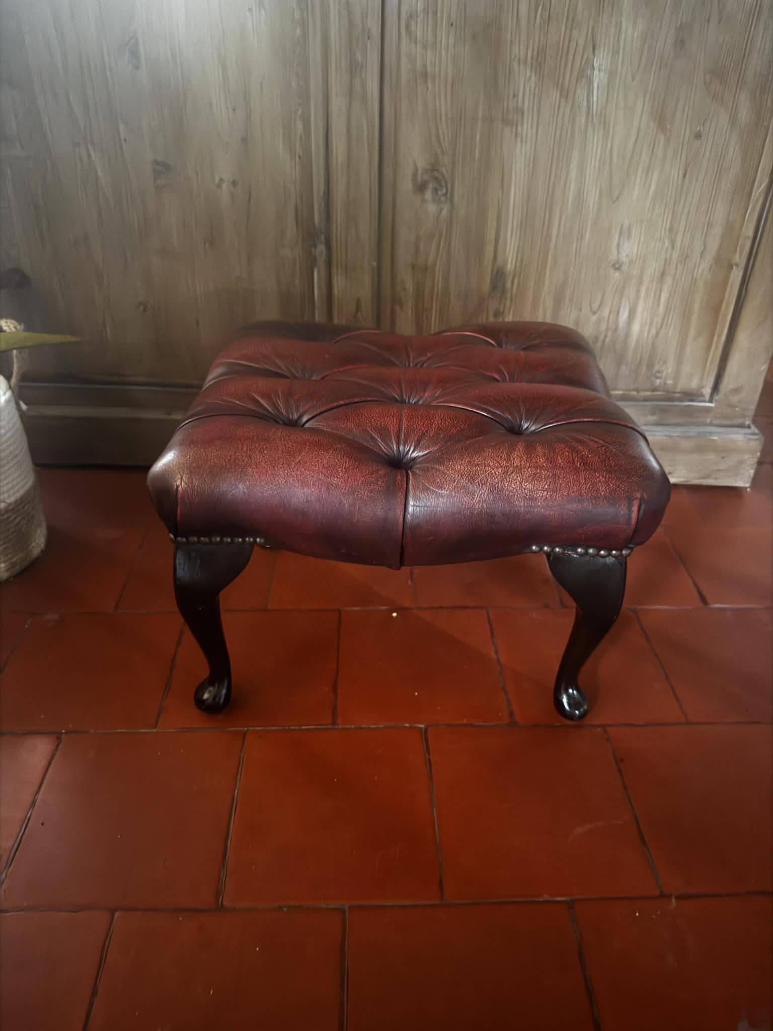 Red leather footrest in Chesterfield style, vintage 1970s.