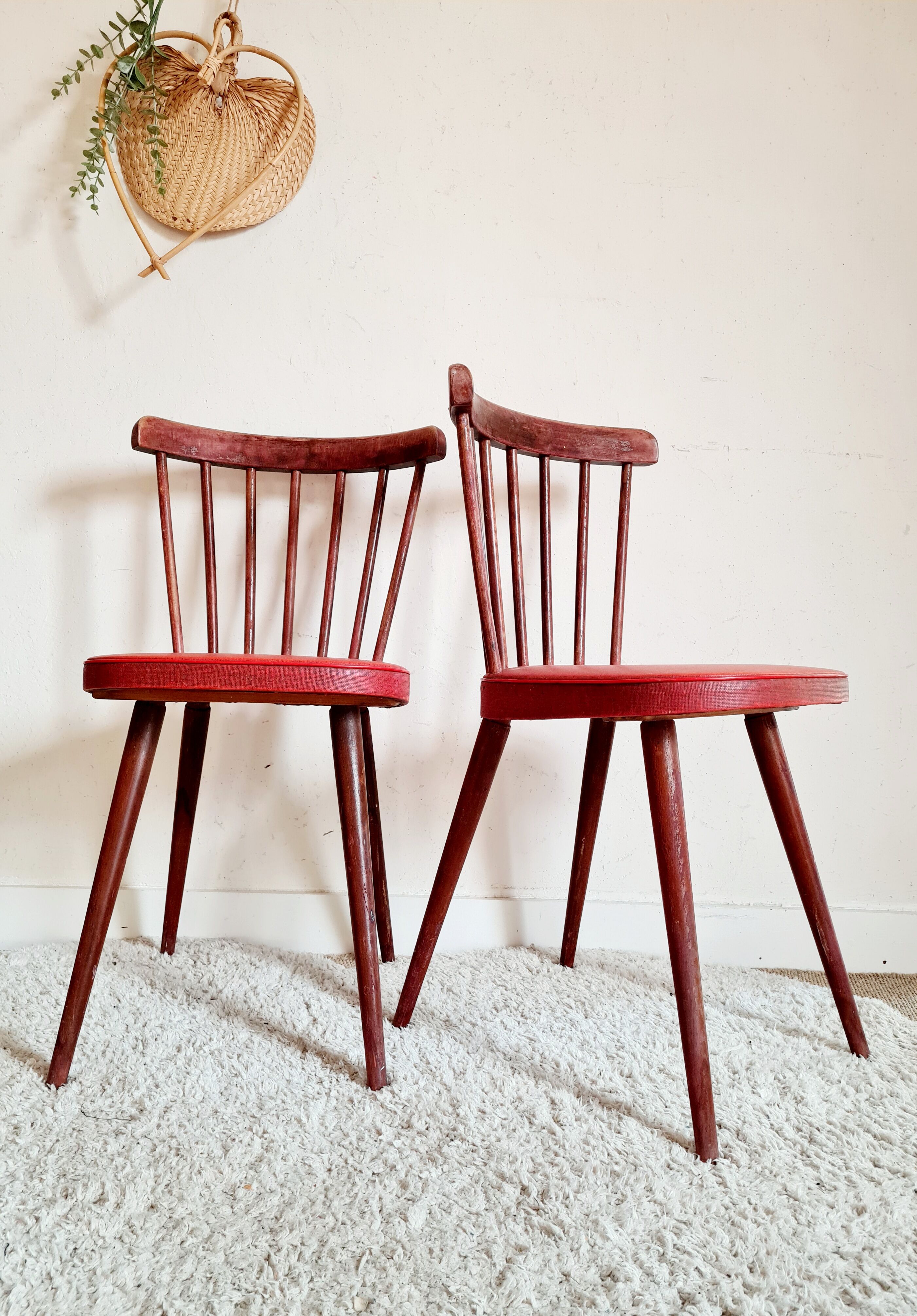 Pair of wooden bistro chairs and red imitation seating