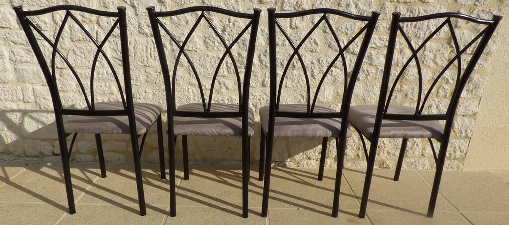 4 black metal chairs with high backs and gray suede tops