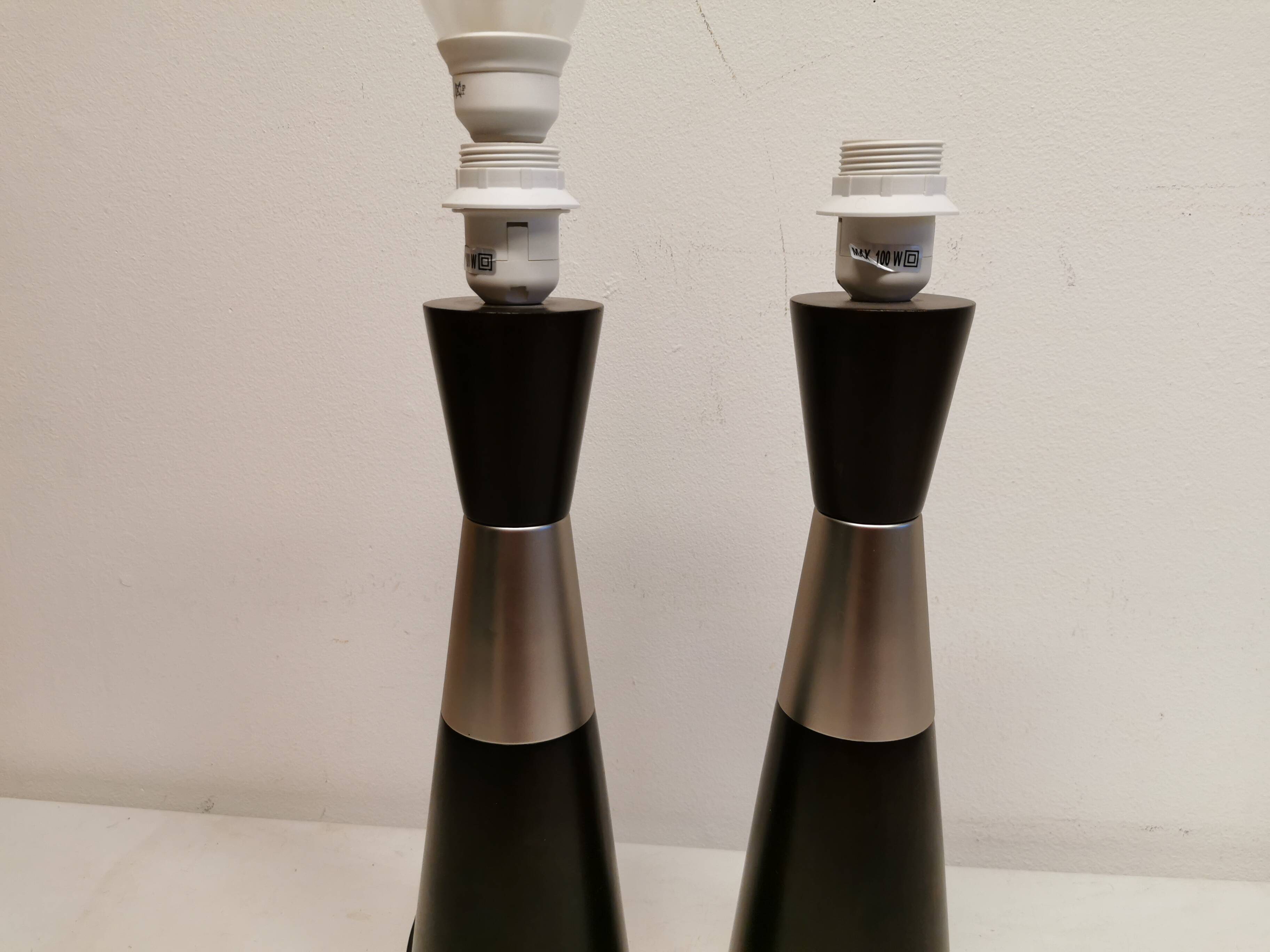 Two table lamps made of dark-stained wood with silver detail in the middle.