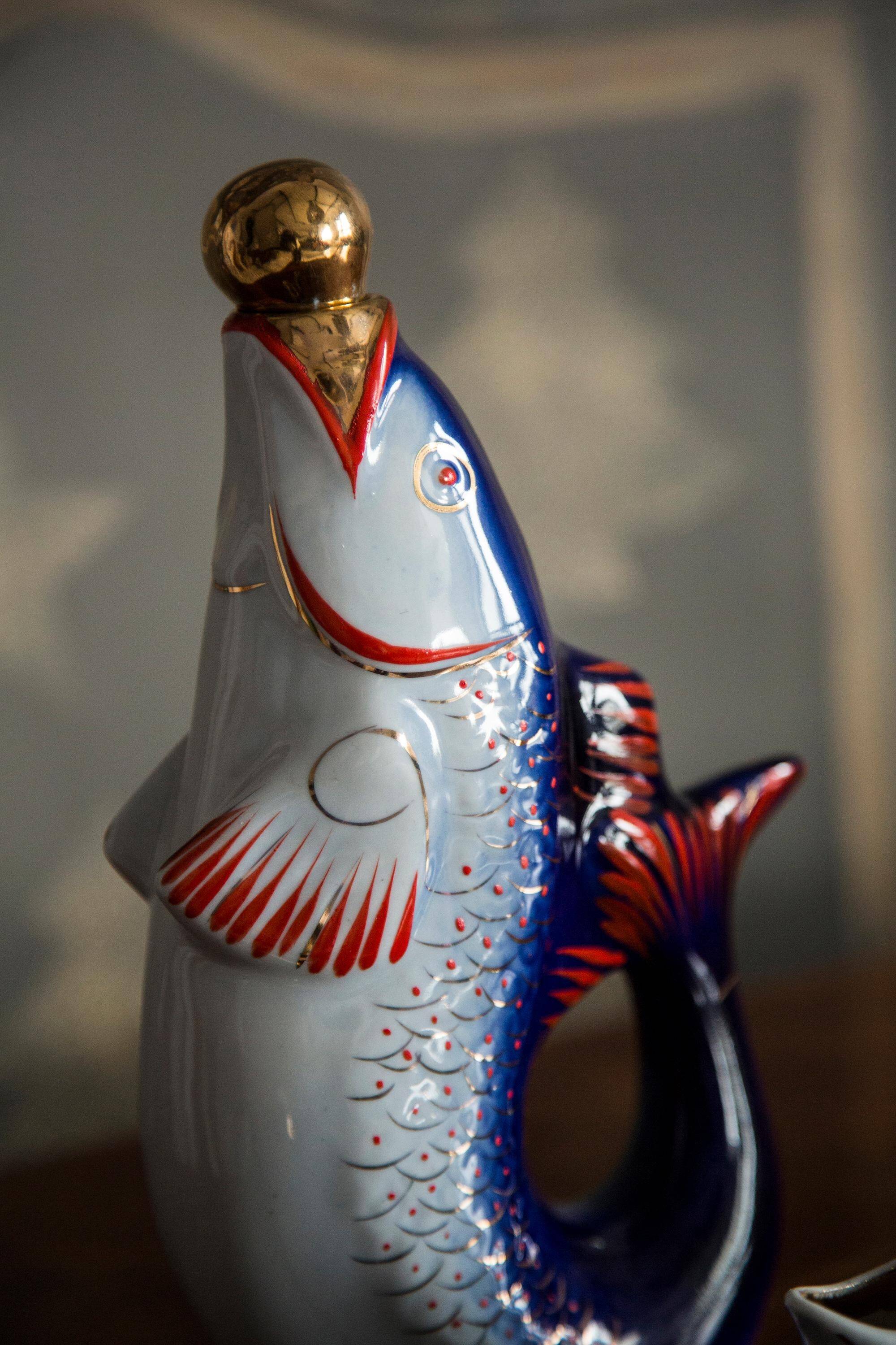 Set of 7 glasses and a glass carafe decorated with blue fish, Mid-Century Modern style, Europe, 1960s.