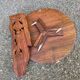 Round folding side table made of carved solid wood.