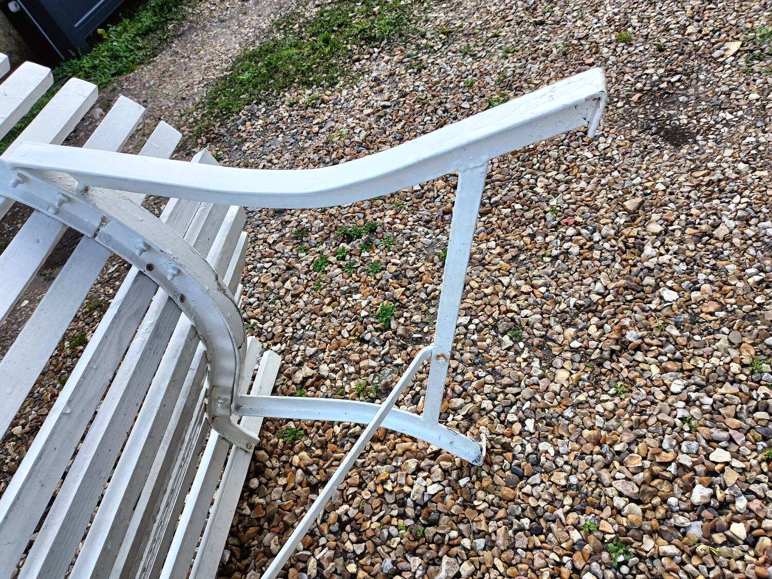 Old garden bench with metal legs and wooden slats