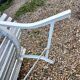 Old garden bench with metal legs and wooden slats