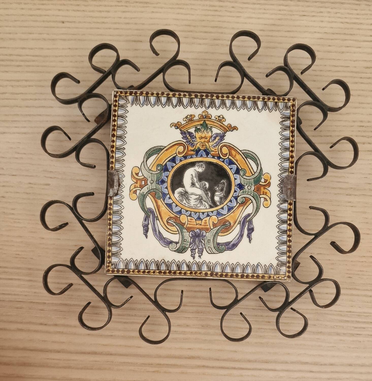 Hand painted gien tile on wrought iron trivet