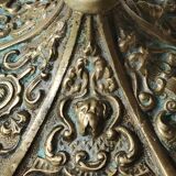 Baroque/Antique style torch candleholder, nineteenth, gilded bronze. Head motifs, volute arabesques