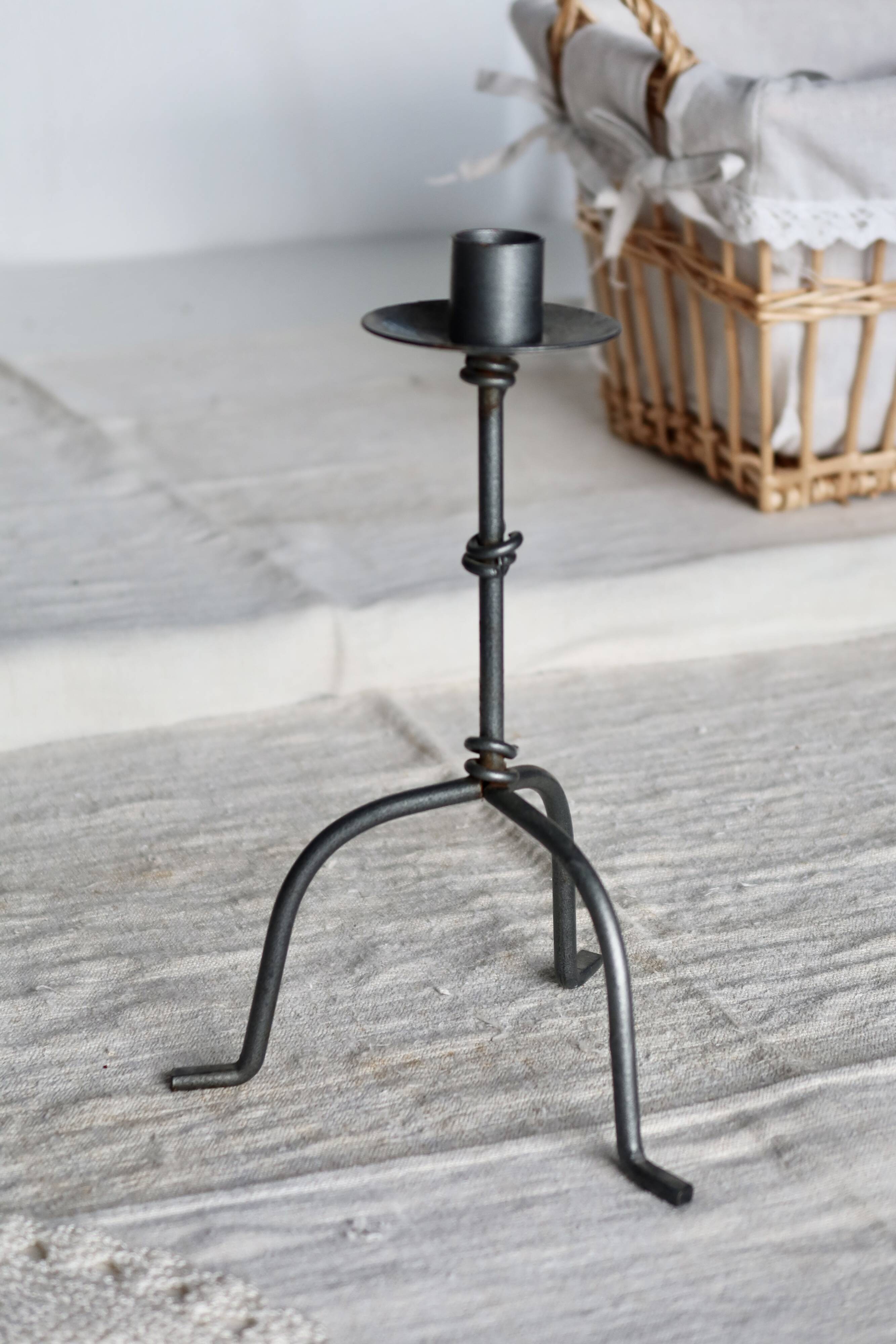 Antique tripod metal candlestick with knot decoration