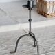 Antique tripod metal candlestick with knot decoration