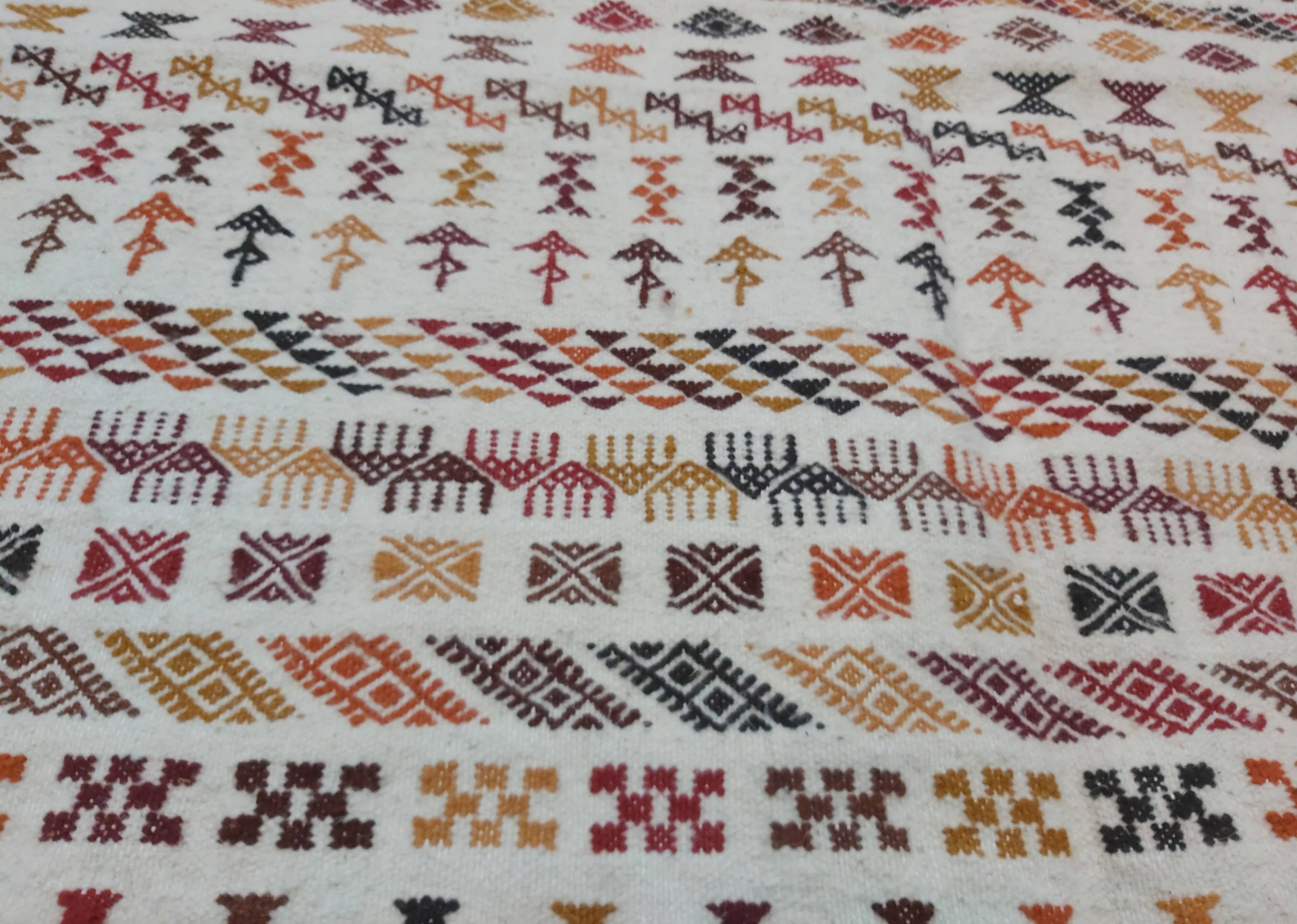 White carpet with multicolored Berber patterns