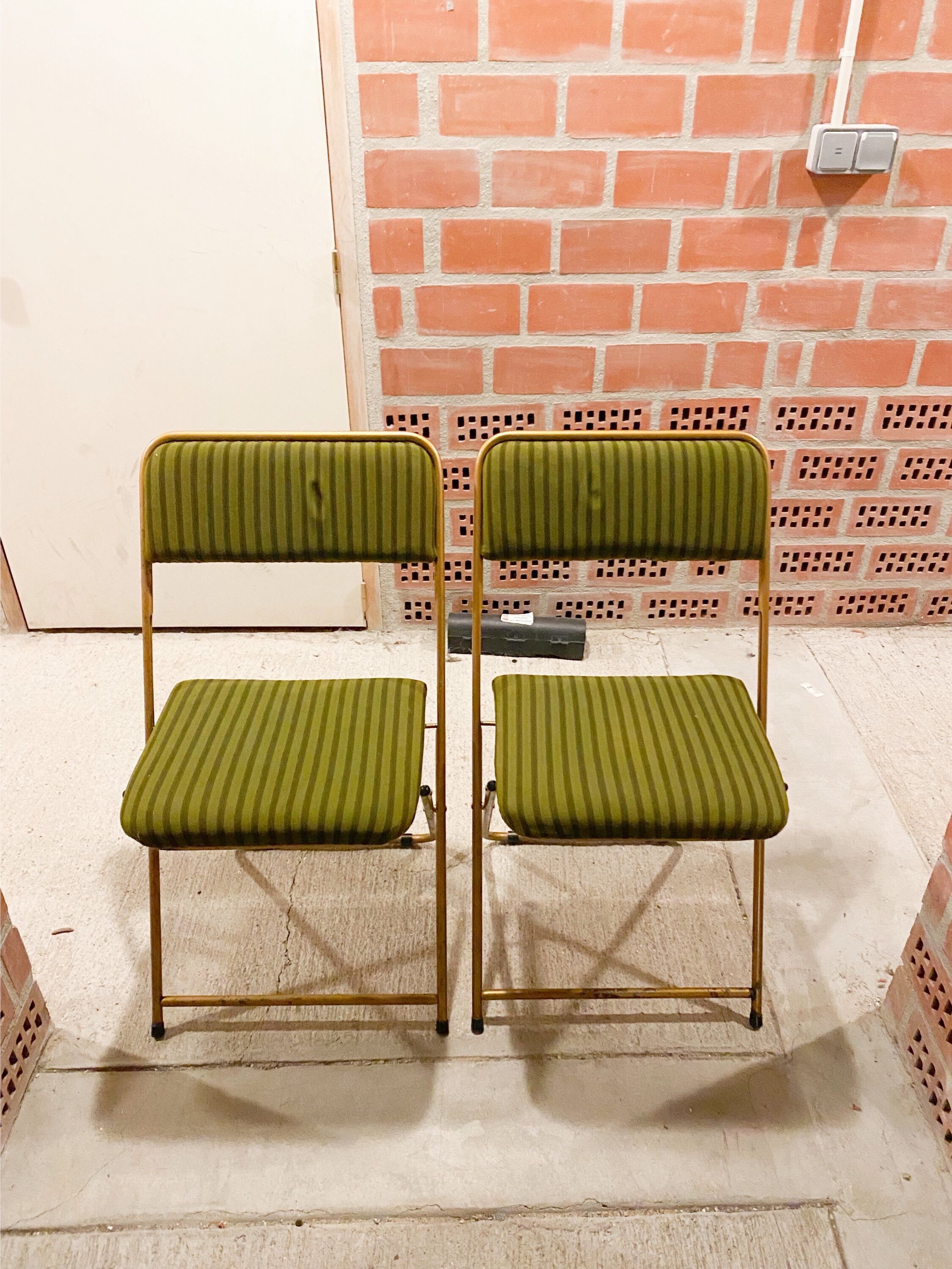 Two green and golden chairs