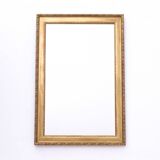 Horizontal mirror in a gold frame.