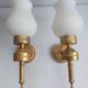 Three Empire style golden torch wall sconces