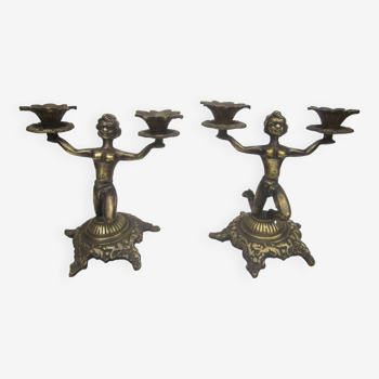 Pair of brass candlesticks: characters
