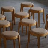 Modern Swedish, set of 14 stackable stools in birch and hessian fabric, 1980s.