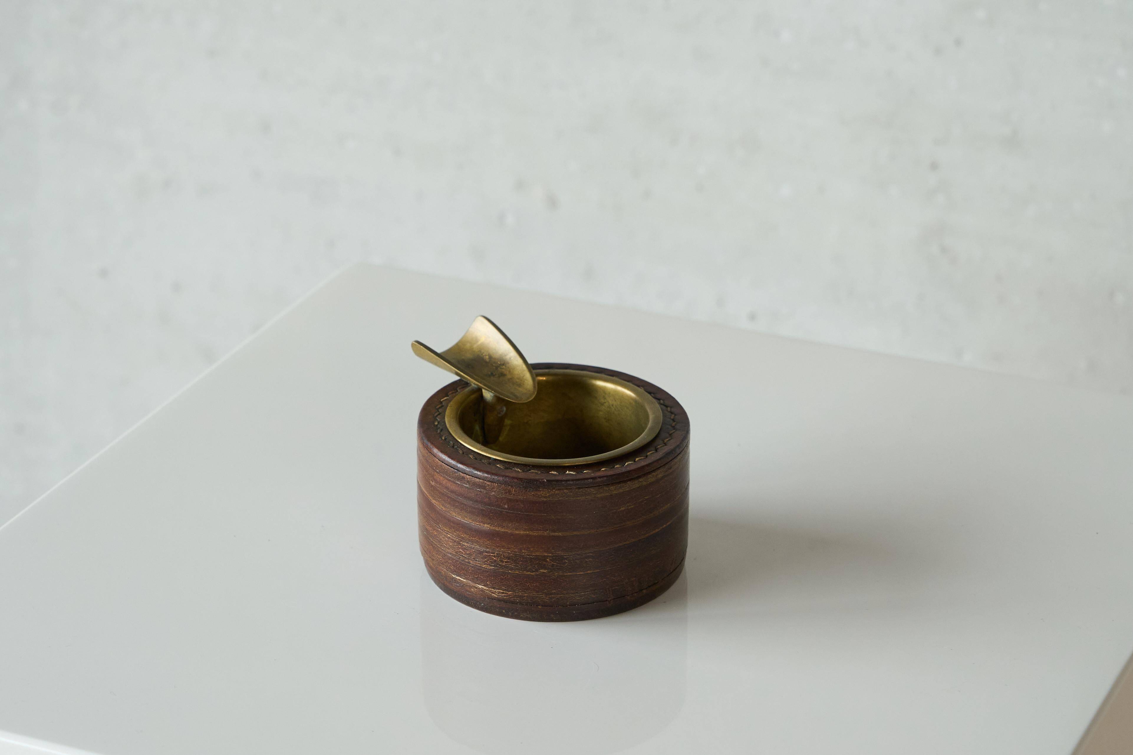 Vintage leather and patinated brass ashtray, 1960s, mid-century design.