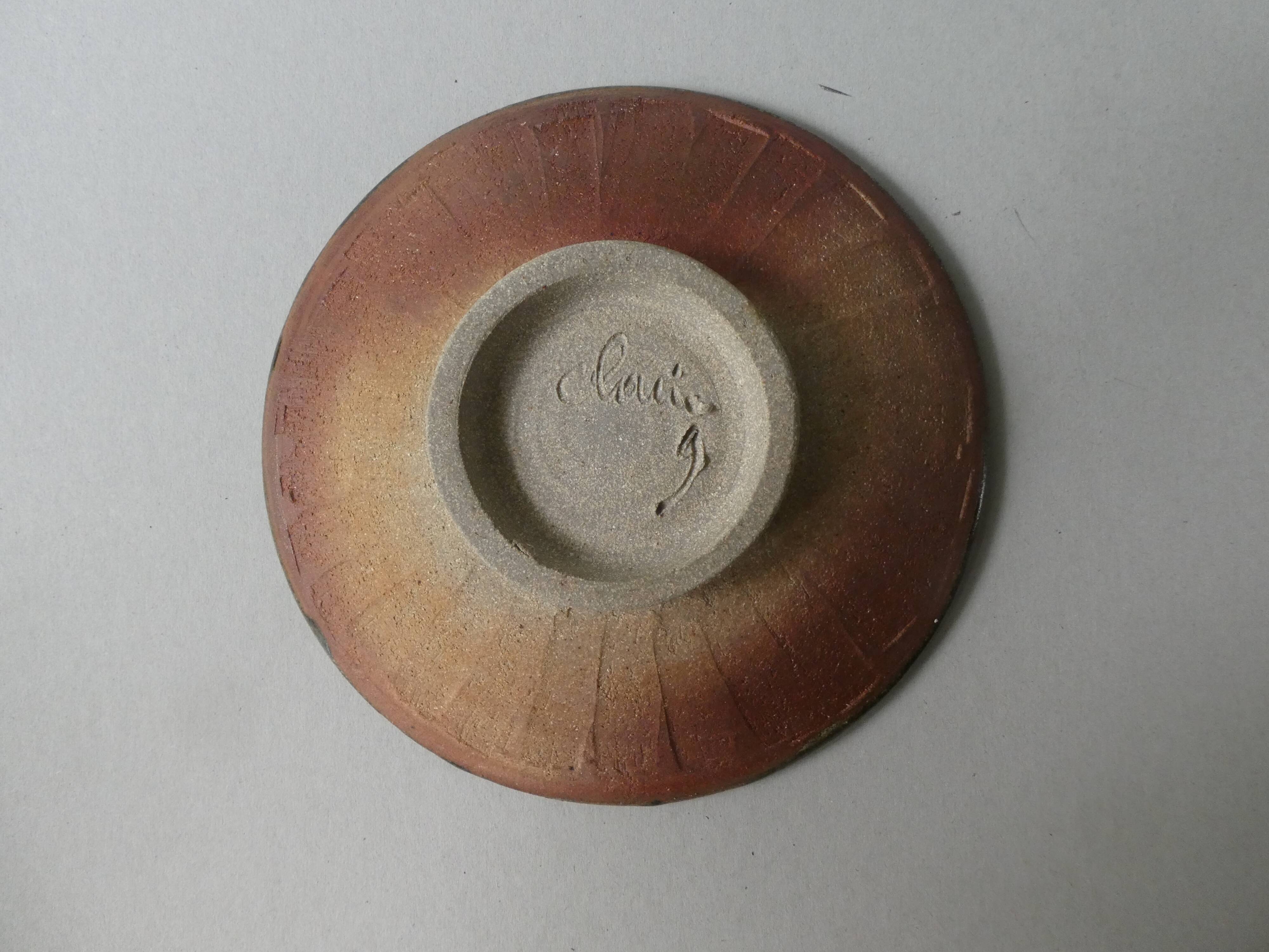 Flat, cut on peedouche, enamelled sandstone, signed