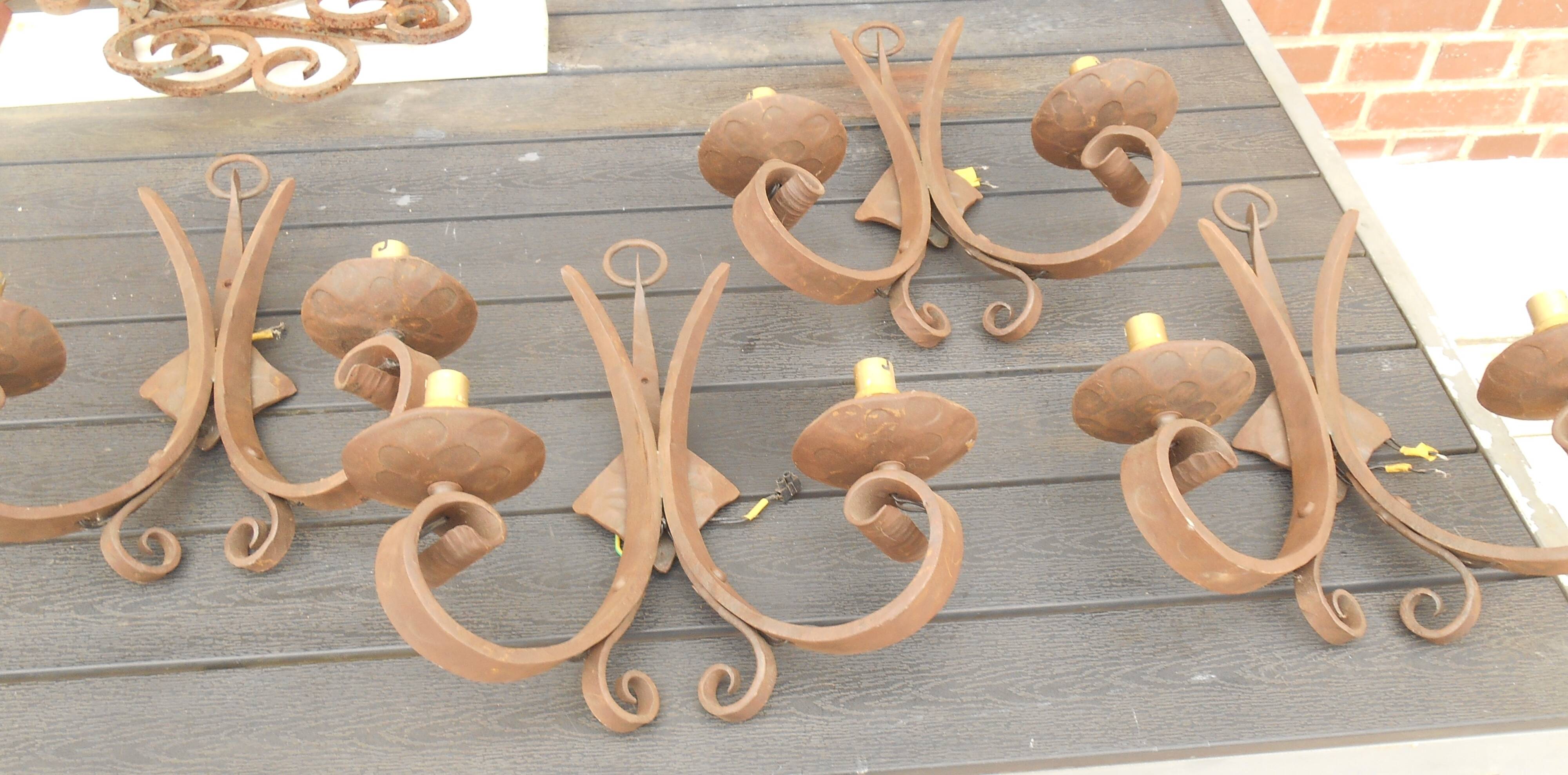 Four antique wrought iron wall lights