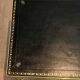 Neoclassical brass coffee table with a black leather top and golden borders from Maison Jansen.