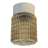 Old wall light in amber glass and plastic fixing base 1970