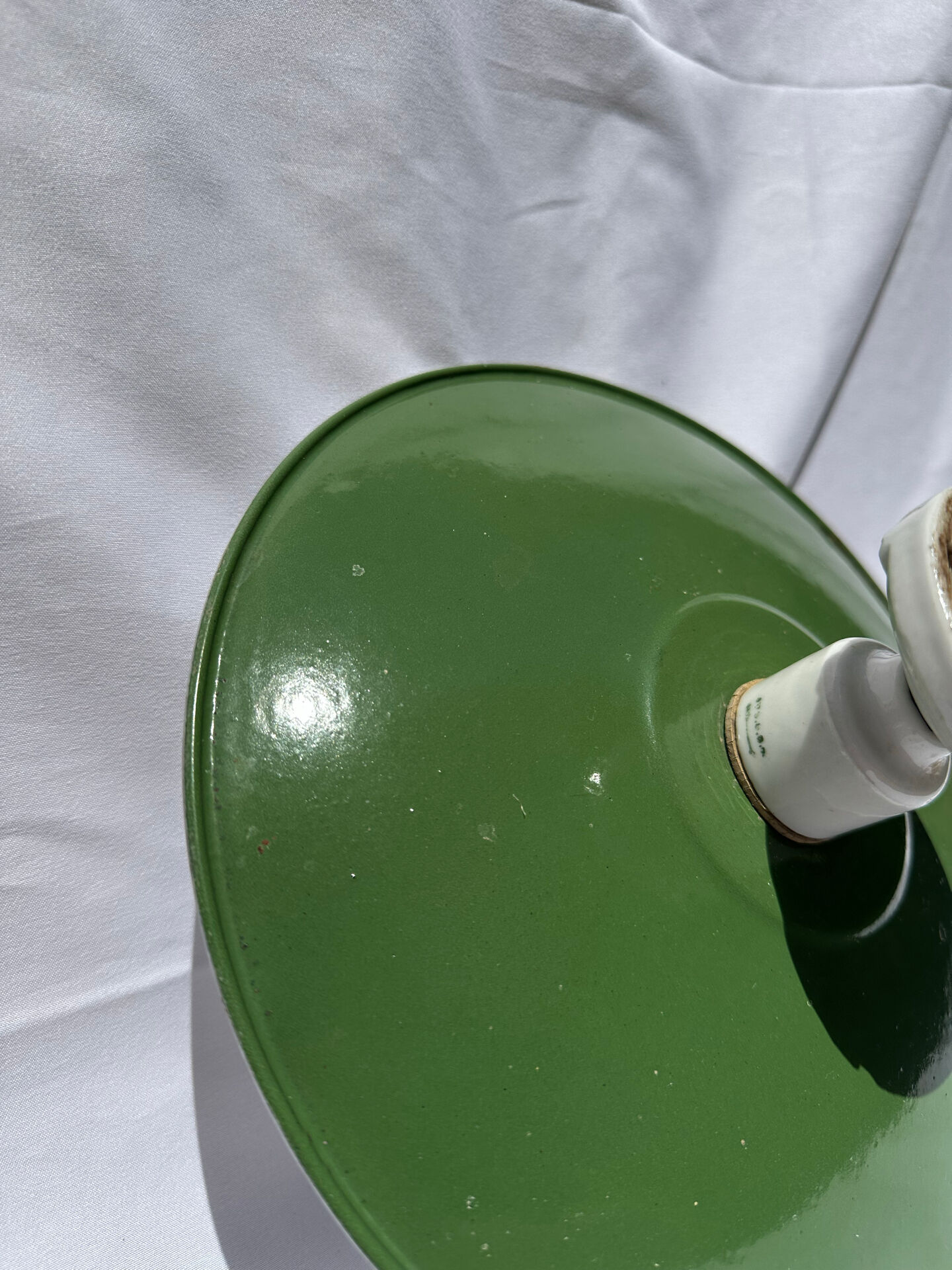 Antique wall lamp with an enamelled metal shade and porcelain.
