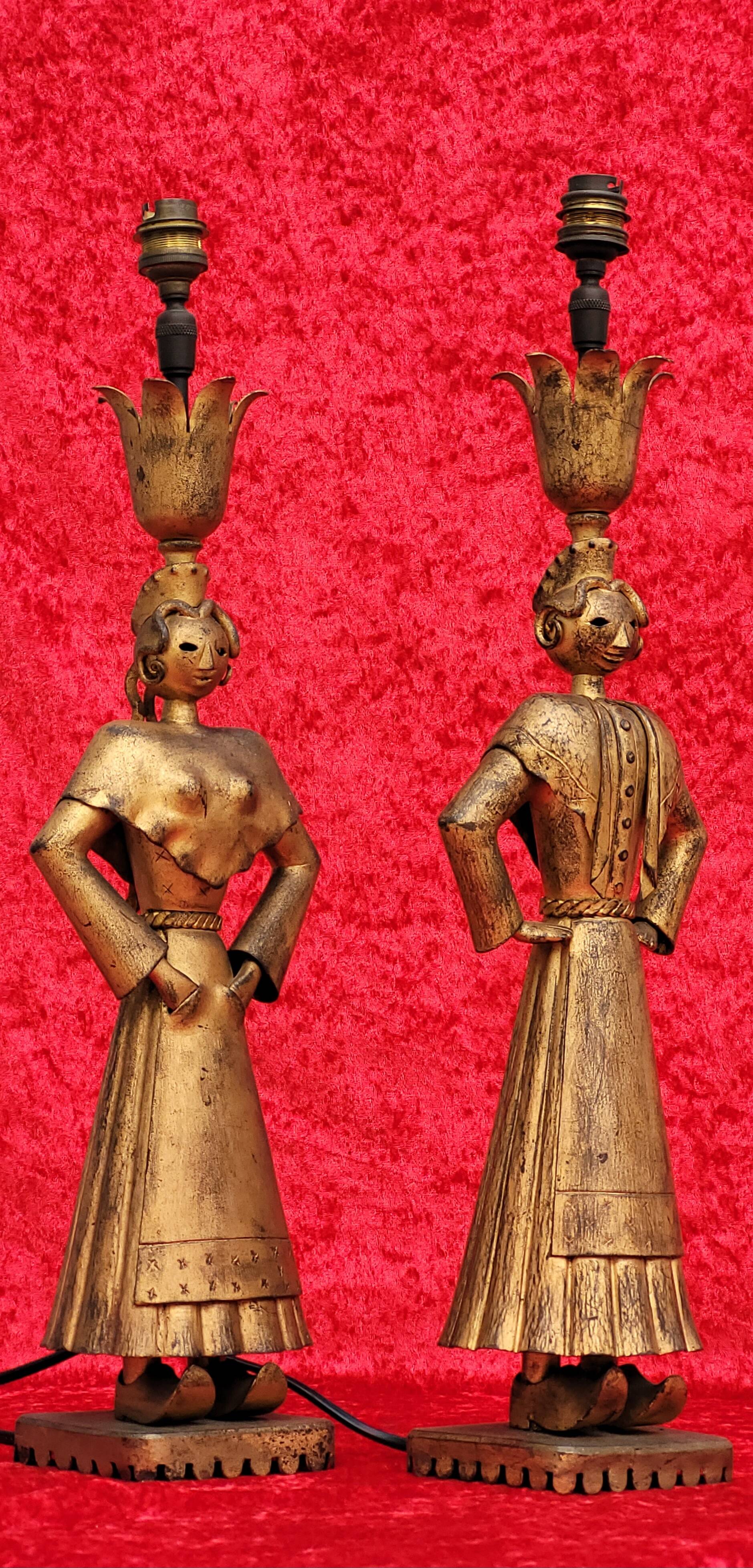 Pair of gilded beaten iron sculpture lamps attributed to Gilbert Poillerat