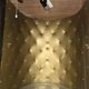 Vintage 50s-60s bar cabinet with tufted upholstery and lighting.