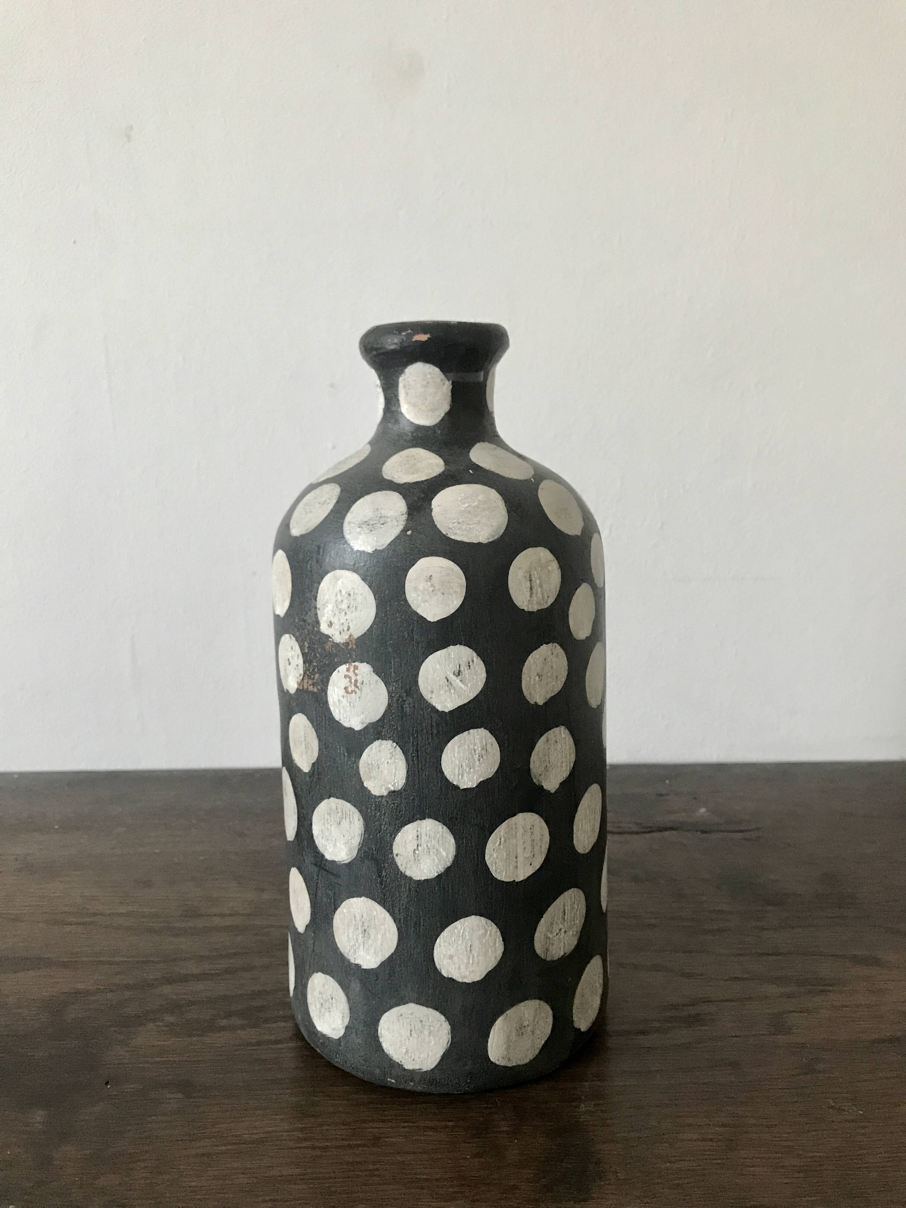 Terracotta vase painted with polka dots