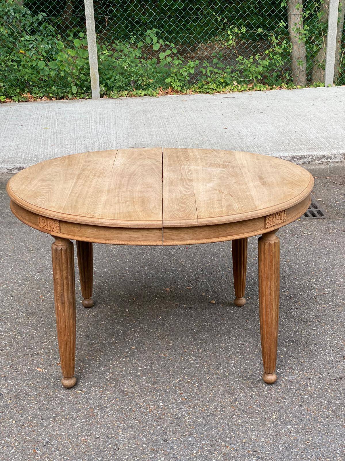 Large stripped solid oak dining table in Louis XVI style with 3 extensions.