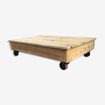 Old wooden school platform bass table on metal wheels