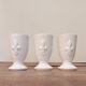 Three antique cups decorated with fleur-de-lis.